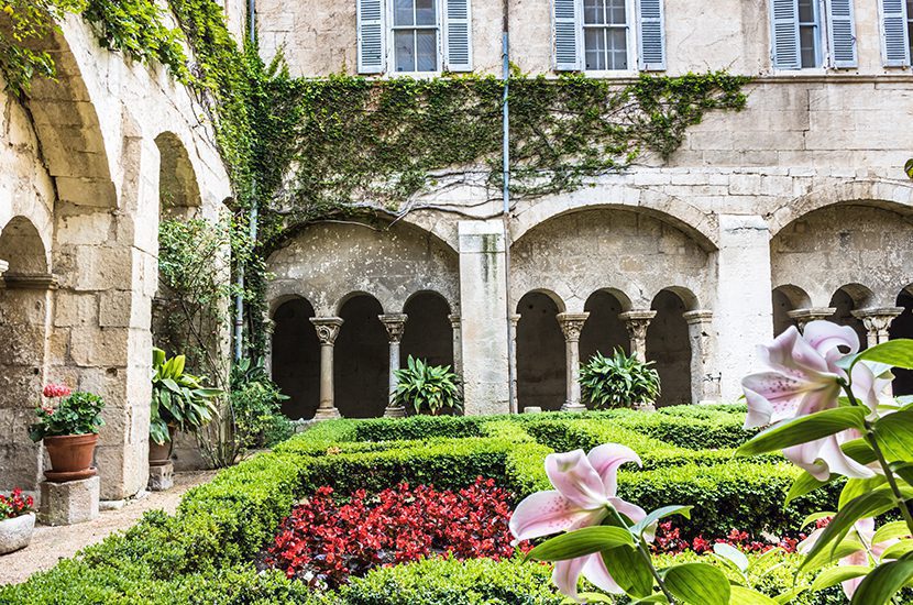 Saint Paul de Mausole, St Remy de Provence. Facade and flower bed of the courtyard in the monaster by Annette Ducasse | World Travel Magazine Saint Paul de Mausole, St Remy de Provence. Facade and flower bed of the courtyard in the monaster by Annette Ducasse