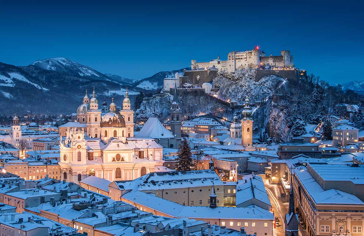Salzburg Cathedral and famous Festung Hohensalzburg illuminated in beautiful twilight during Christmas, Image by canadastock, shutterstock | World Travel Magazine Salzburg Cathedral and famous Festung Hohensalzburg illuminated in beautiful twilight during Christmas, Image by canadastock, shutterstock